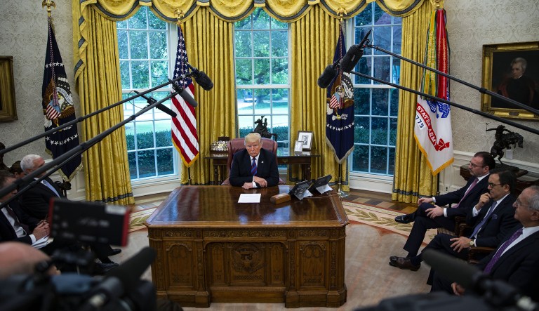 U.S. President Donald Trump listens during a phone conversation with Enrique Pena Nieto, Mexico's president, not pictured, in the Oval Office of the White House in Washington, D.C., U.S., on Monday, Aug. 27, 2018. TrumpÂ said he would terminate the North American Free Trade Agreement and sign a new trade accord with Mexico, potentially leaving Canada out of the bloc.