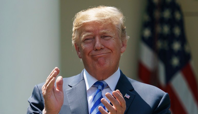 President Donald Trump applauds during an event about prescription drug prices with Health and Human Services Secretary Alex Azar in the Rose Garden of the White House in Washington, Friday, May 11, 2018.