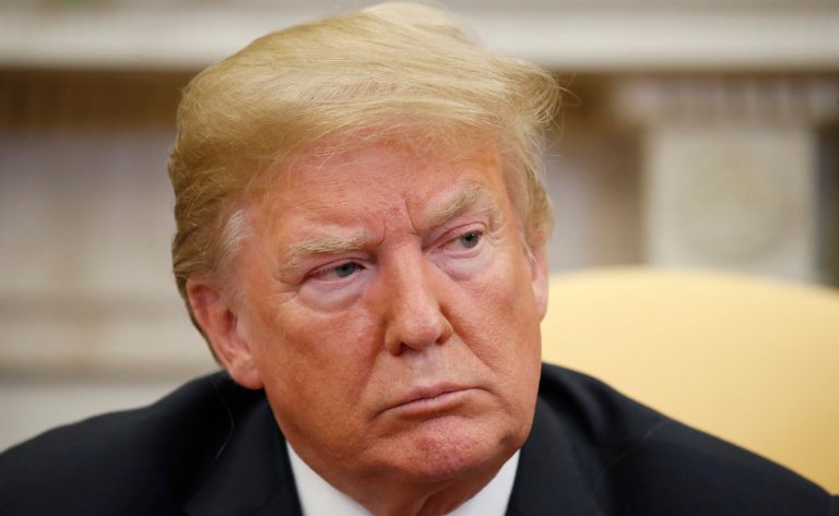 President Donald Trump listens during a meeting with Joshua Holt, who was recently released from a prison in Venezuela, in the Oval Office of the White House, Saturday, May 26, 2018, in Washington.