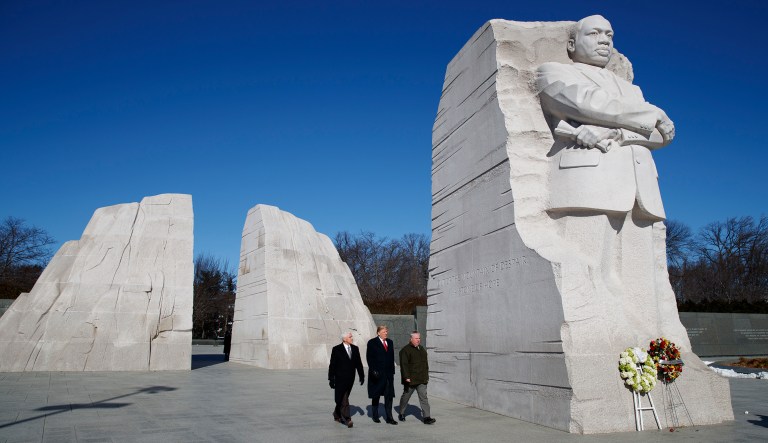 President Donald Trump, center, and Vice President Mike Pence, left, visit the Martin Luther King Jr. Memorial, Monday, Jan. 21, 2019, in Washington.