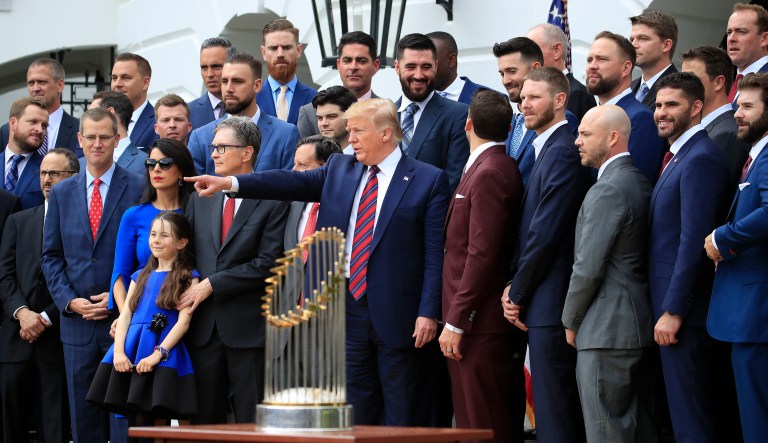 President Donald Trump, center, joins the Boston Red Sox for a group picture during a ceremony honoring the 2018 World Series baseball champion to the White House in Washington, Thursday, May 9, 2019.