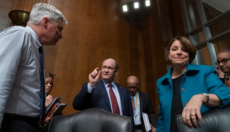Democratic members of the Senate Judiciary Committee, from left, Sen. Sheldon Whitehouse, D-R.I., Sen. Chris Coons, D-Del., and Sen. Amy Klobuchar, D-Minn., confer after questioning Attorney General William Barr about special counsel Robert Mueller's Russia report, on Capitol Hill in Washington, Wednesday, May 1, 2019.
