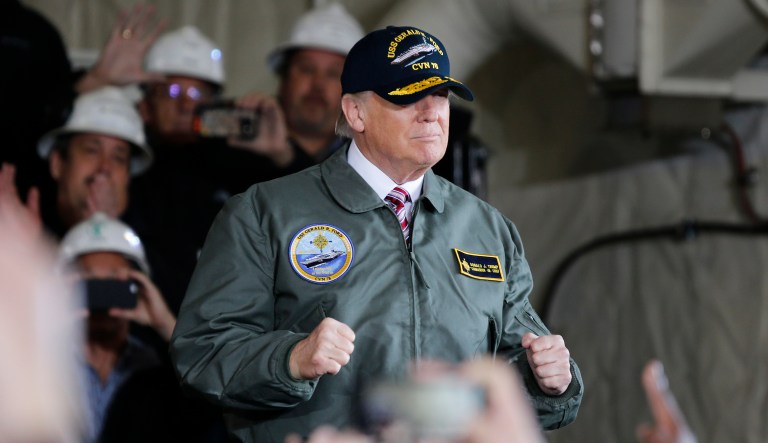 President Donald Trump reacts to the crowd as he arrives to speak to navy and shipyard personnel aboard nuclear aircraft carrier Gerald R. Ford at Newport News Shipbuilding in Newport News, Va., Thursday, March 2, 2017. The ship which is still under construction is due to be delivered to the Navy later this year.