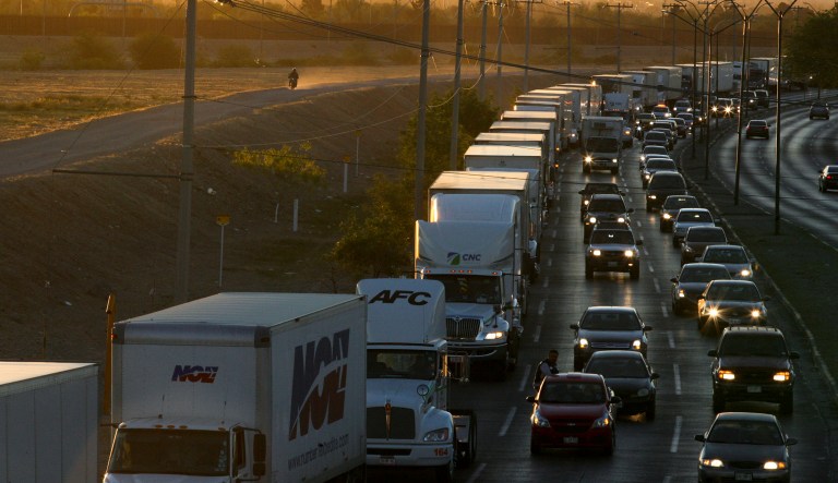 In this April 9, 2019, file photo, trucks wait to cross the border with the U.S. in Ciudad Juarez, Mexico. 