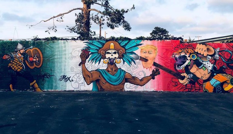 This photo shows a mural in California that has caused controversy due to its depiction of President Trump's head on a spear.