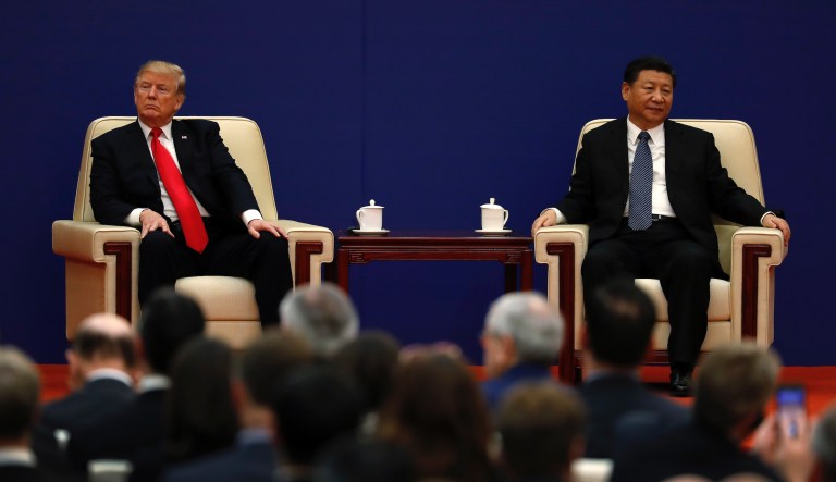 In this Nov. 9, 2017, photo, U.S. President Donald Trump, left, sits next to Chinese President Xi Jinping during a business event at the Great Hall of the People in Beijing. The brewing China-U.S. trade conflict features two leaders whoâve expressed friendship but are equally determined to pursue their nation's interests and their own political agendas. 