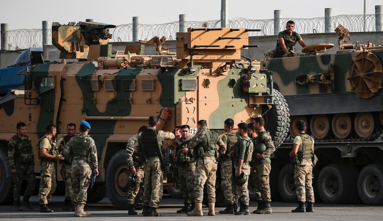 Turkish soldiers prepare to enter Syria aboard an armoured personnel carrier at the border with Syria in Karkamis, Gaziantep province, southeastern Turkey, Tuesday, Oct. 15, 2019. Turkey defied growing condemnation from its NATO allies to press ahead with its invasion of northern Syria on Tuesday, shelling suspected Kurdish positions near the border amid reports that Syrian Kurds had retaken a key town.