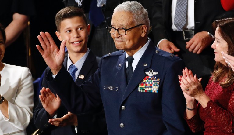 Tuskegee airman Charles McGee, 100, and his great grandson Iain Lanphier react as President Donald Trump delivers his State of the Union address to a joint session of Congress on Capitol Hill in Washington, Tuesday, Feb. 4, 2020.