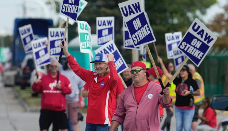 United Auto Workers members march while holding signs at a union rally held near a Stellantis factory Wednesday, Aug. 23, 2023, in Detroit. 