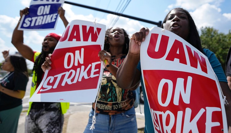 United Auto Workers of local 868 demonstrate to passing vehicles near a Stellantis parts distribution center on Friday, Sept. 22, 2023, in Morrow, Georgia.