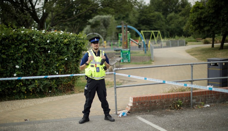 A British police community support officer guards a cordon outside the Queen Elizabeth Gardens park in Salisbury, England, Thursday, July 5, 2018. British officials are seeking clues Thursday in the rush to understand how two Britons were exposed to the military-grade nerve agent Novichok.