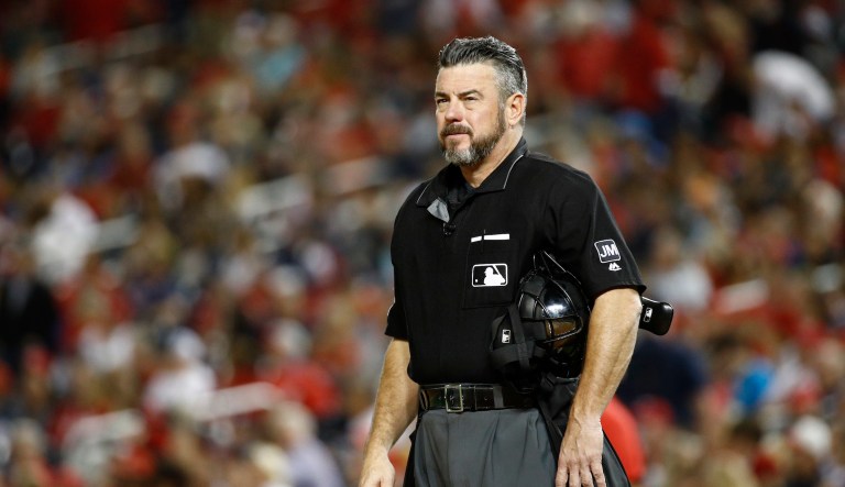 Umpire Rob Drake stands on the field in the x inning of a baseball game between the Atlanta Braves and the Washington Nationals, Friday, Sept. 13, 2019, in Washington. 