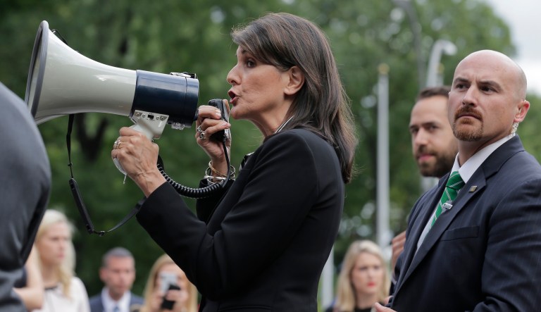 Surrounded by security, U.S. Ambassador to the United Nations Nikki Haley speaks briefly to people at a protest against Venezuelan President Nicolas Maduro outside U.N. headquarters in New York, Thursday, Sept. 27, 2018.
