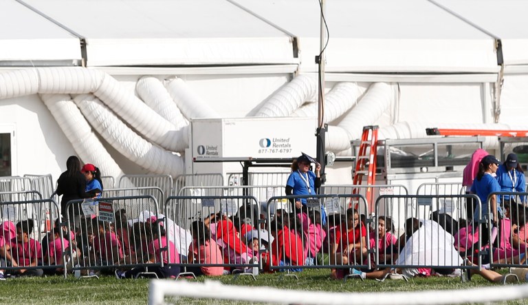 Immigrant children are shown outside a former Job Corps site that now houses them, Monday, June 18, 2018, in Homestead, Fla.