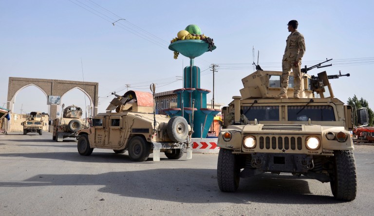 In this Sunday, Aug. 12, 2018, photo, Afghan security personnel patrol in the city of Ghazni.
