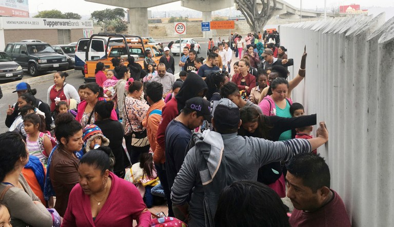 In this Monday, June 4, 2018 photo, people seeking political asylum in the United States line up to be interviewed in Tijuana, Mexico, just across the U.S. border south of San Diego.