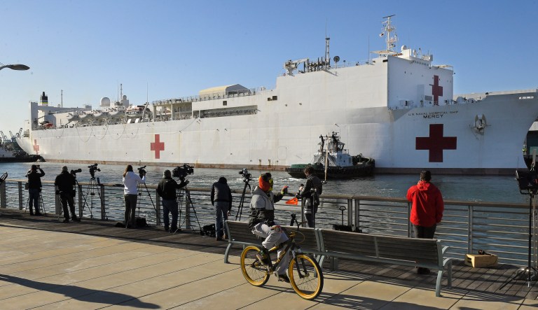 The USNS Mercy enters the Port of Los Angeles, Friday, March 27, 2020, in Los Angeles. The The 1,000-bed Navy hospital ship is expected to help take the load off Los Angeles area hospitals as they treat coronavirus patients. The new coronavirus causes mild or moderate symptoms for most people, but for some, especially older adults and people with existing health problems, it can cause more severe illness or death.