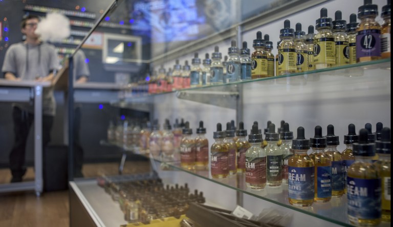 Flavored vape juice bottles are displayed for sale at the Betamorph E-Cigs store in Albuquerque, New Mexico, U.S., on Saturday, Dec. 10, 2016. Sales in the U.S. vapor-device market are projected to rise by 21% annually through 2020, based on Euromonitor Passport data.