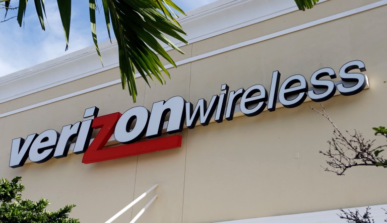This Friday, Aug. 11, 2017, photo shows a Verizon wireless sign in Miami. Verizon is raising the price on its unlimited plan while introducing a slightly cheaper, more limited version of it as wireless carriers battle each other for customers.