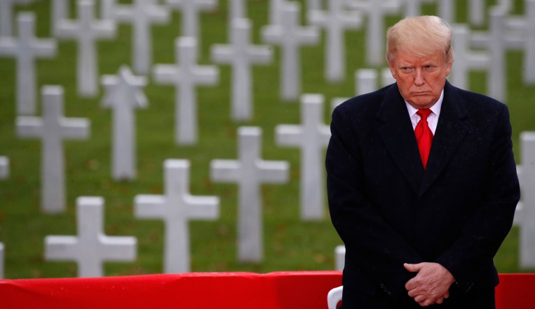 President Donald Trump stands in front of headstones during an American Commemoration Ceremony, Sunday Nov. 11, 2018, at Suresnes American Cemetery near Paris. Trump is attending centennial commemorations in Paris this weekend to mark the Armistice that ended World War I.