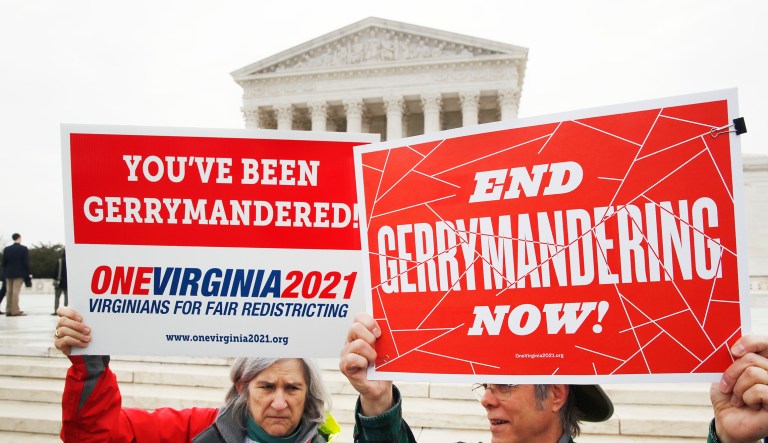 Sara Fitzgerald, left, and Michael Martin, both with the group One Virginia, protest gerrymandering in front of the Supreme Court, Wednesday, March 28, 2018, in Washington where the court will hear arguments on a gerrymandering case.