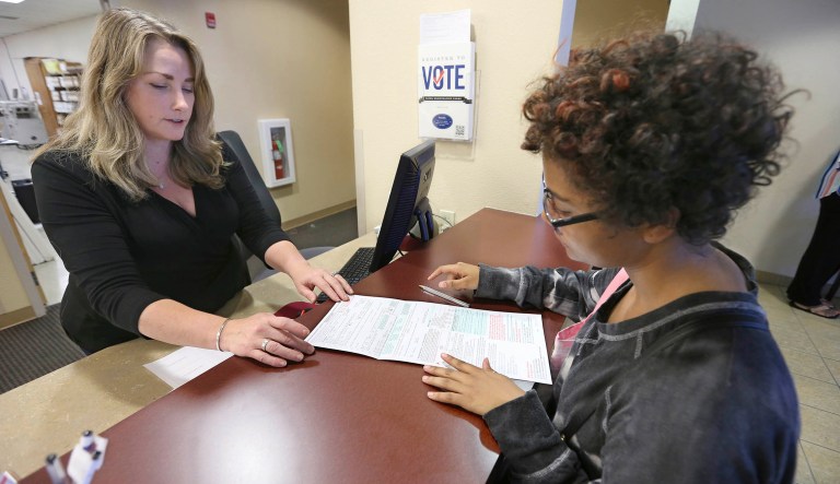 Voters go to the polls during early voting at the Hamilton County Board of Elections, Sunday, Nov. 4, 2018, in Cincinnati.