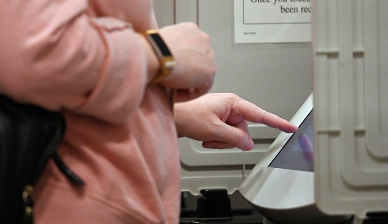A woman casts her ballot ahead of the Tuesday, Nov. 6, general election at Jim Miller Park, Saturday, Oct. 27, 2018, in Marietta, Ga.