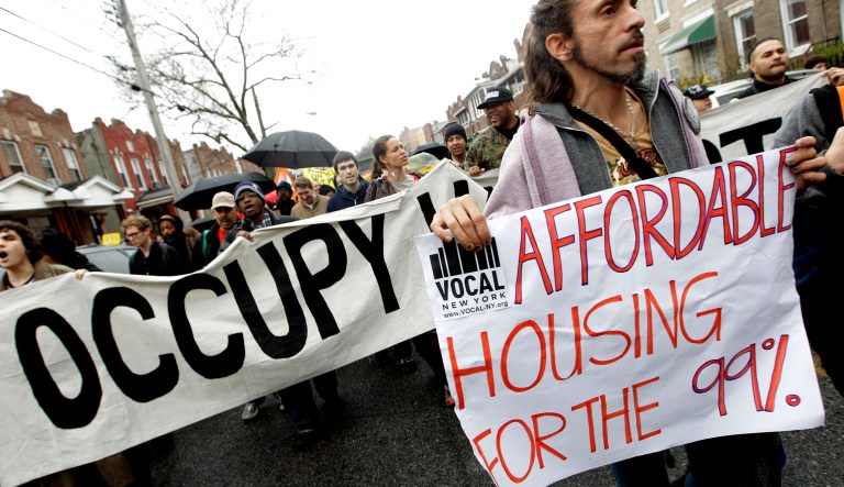 Occupy Wall Street activists march during a tour of foreclosed homes in the East New York neighborhood of the Brooklyn borough of New York, Tuesday, Dec. 6, 2011.  Finding it increasingly difficult to camp in public spaces, occupy protesters across the country are reclaiming foreclosed homes and boarded-up properties, signaling a tactical shift for the movement against wealth inequality. Groups in more than 25 cities held protests Tuesday on behalf of homeowners facing evictions.