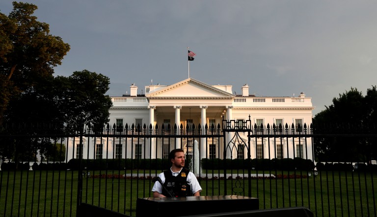 A member of the Secret Service Police stands guard outside the fence of the White House on Pennsylvania Ave., Saturday, May 18, 2019, in Washington.
