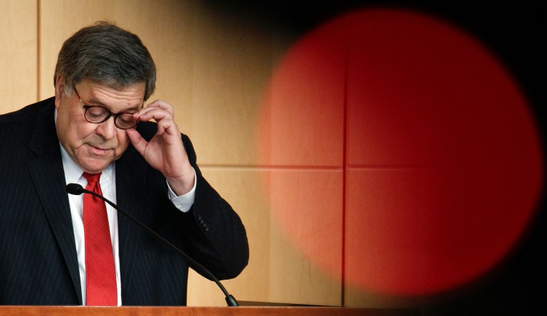 Attorney General Barr William Barr adjusts his glasses as he speaks at the Securities and Exchange Commission (SEC) Criminal Coordination Conference, Thursday, Oct. 3, 2019, at the SEC in Washington. 