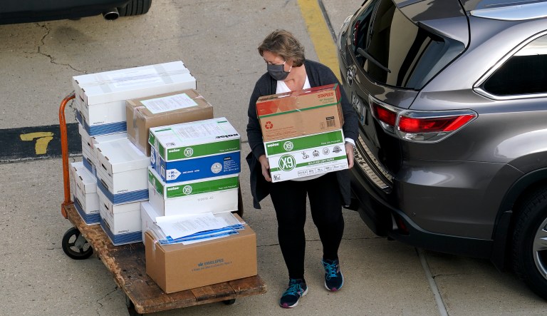 Election officials from around Dane County bring ballots in, Thursday, Nov., 19, 2020 to the Monona Terrace in Madison, Wis. for the recount that begins Friday. 