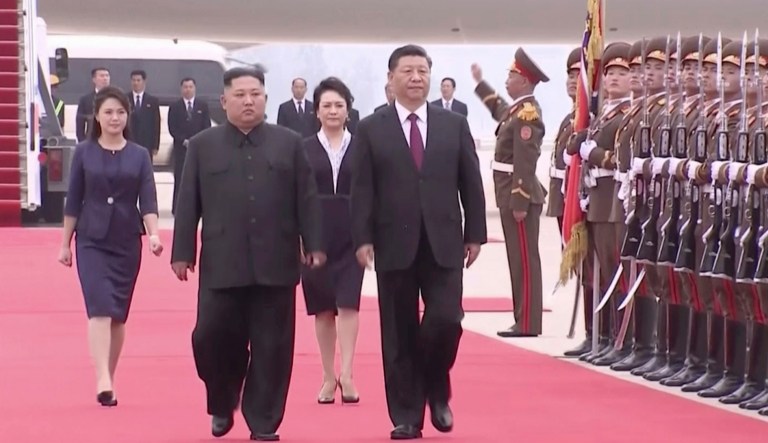 In this image taken from a video footage run by China's CCTV, North Korean leader Kim Jong Un, left, and Chinese President Xi Jinping, right, walk together on Xi's arrival at an airport in Pyongyang, North Korea, Thursday, June 20, 2019.