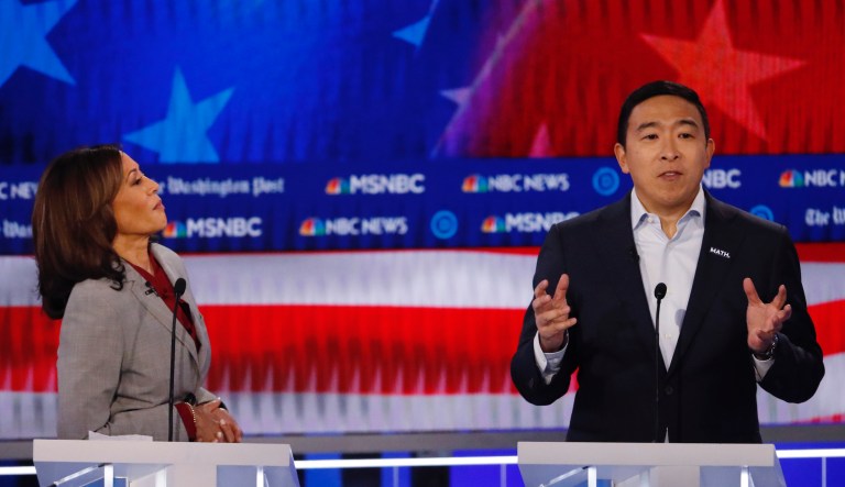 Democratic presidential candidate former technology executive Andrew Yang speaks as Democratic presidential candidate Sen. Kamala Harris, D-Calif., looks on during a Democratic presidential primary debate, Wednesday, Nov. 20, 2019, in Atlanta. 