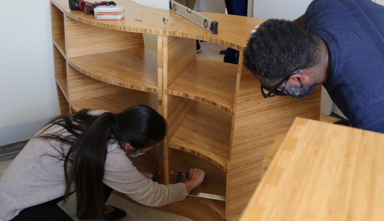 Freedom Reads founder and Director Dwayne Betts (right) works with MASS Design Principal Regina Chen (left).