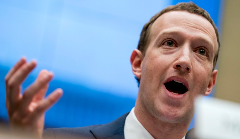 Facebook's CEO Mark Zuckerberg listens to French President Emmanuel Macron after a family picture with guests of the "Tech for Good" Summit at the Elysee Palace in Paris, France, Wednesday May 23, 2018. 
