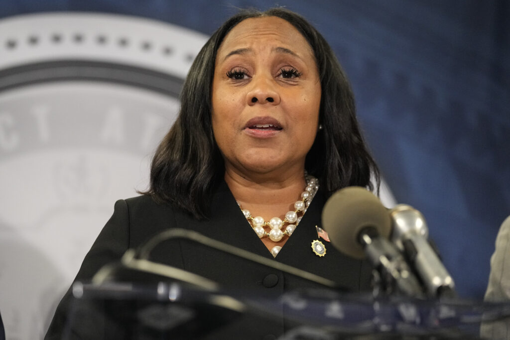 FILE - Fulton County, Ga., District Attorney Fani Willis speaks during a news conference at the Fulton County Government Center, Aug. 14, 2023, in Atlanta, after an indictment was returned against former President Donald Trump and 18 others accusing them of scheming to subvert the will of Georgia voters to keep the Republican president in the White House after he lost to Democrat Joe Biden. A December 2020 meeting of Republican electors in Georgia was a key element in a guilty plea on Friday, Oct. 20, 2023 by attorney Kenneth Chesebro. (AP Photo/John Bazemore, File)