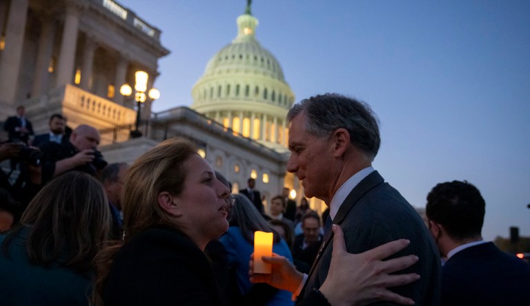 Adi Marciano, left, whose daughter Noa Marciano, 19, is being held hostage, speaks with Rep. French Hill, R-Ark., as members of Congress hold a candlelight vigil for Israel on the steps of the U.S. House of Representatives, Tuesday, Nov. 7, 2023, in Washington. (AP Photo/Alex Brandon)