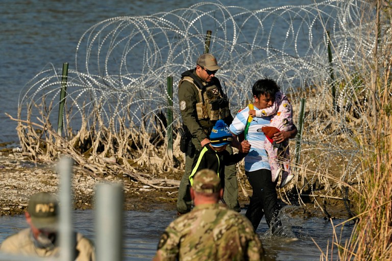 Migrants are taken into custody by officials at the Texas-Mexico border, Wednesday, Jan. 3, 2024, in Eagle Pass, Texas. (AP)