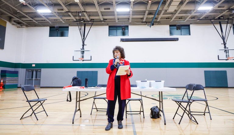 Precinct captain Linda Westphal announces instructions during Coralville precinct six caucus at Northwest Junior High School in Coralville, Iowa, on Monday, Jan. 15, 2024. (Jim Slosiarek/The Gazette via AP)