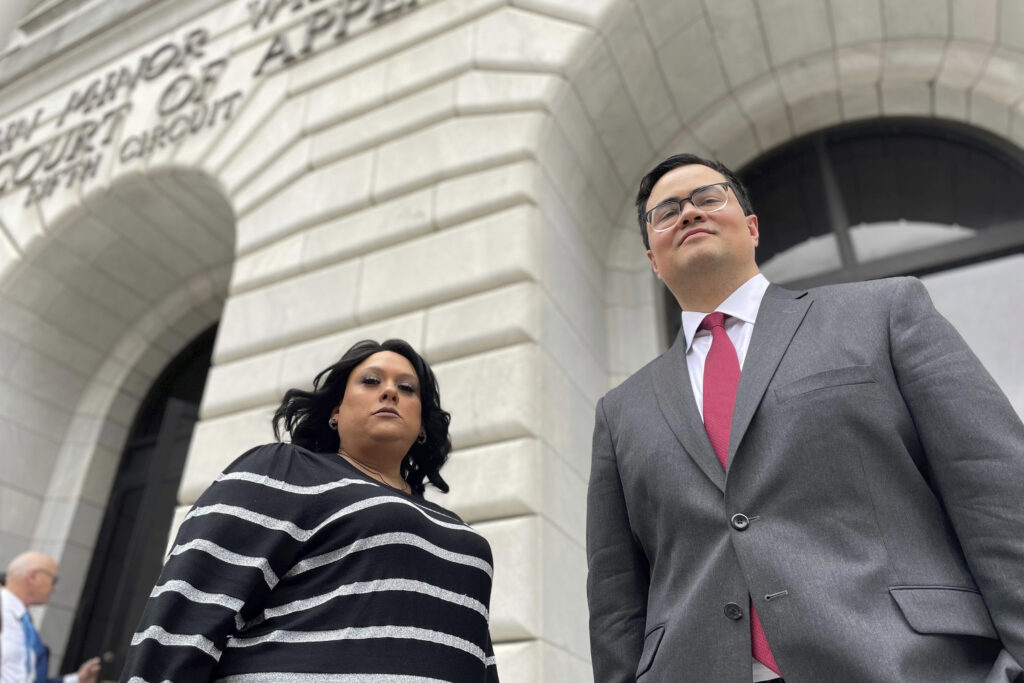 Priscilla Villarreal, a citizen journalist from Laredo, Texas, who claims she was improperly arrested stands outside the 5th U.S. Circuit Court of Appeals building in New Orleans, Jan. 25, 2023, with her attorney, J.T. Morris, after the court heard arguments in Villarreal's lawsuit against Laredo and Webb County, Texas, authorities.