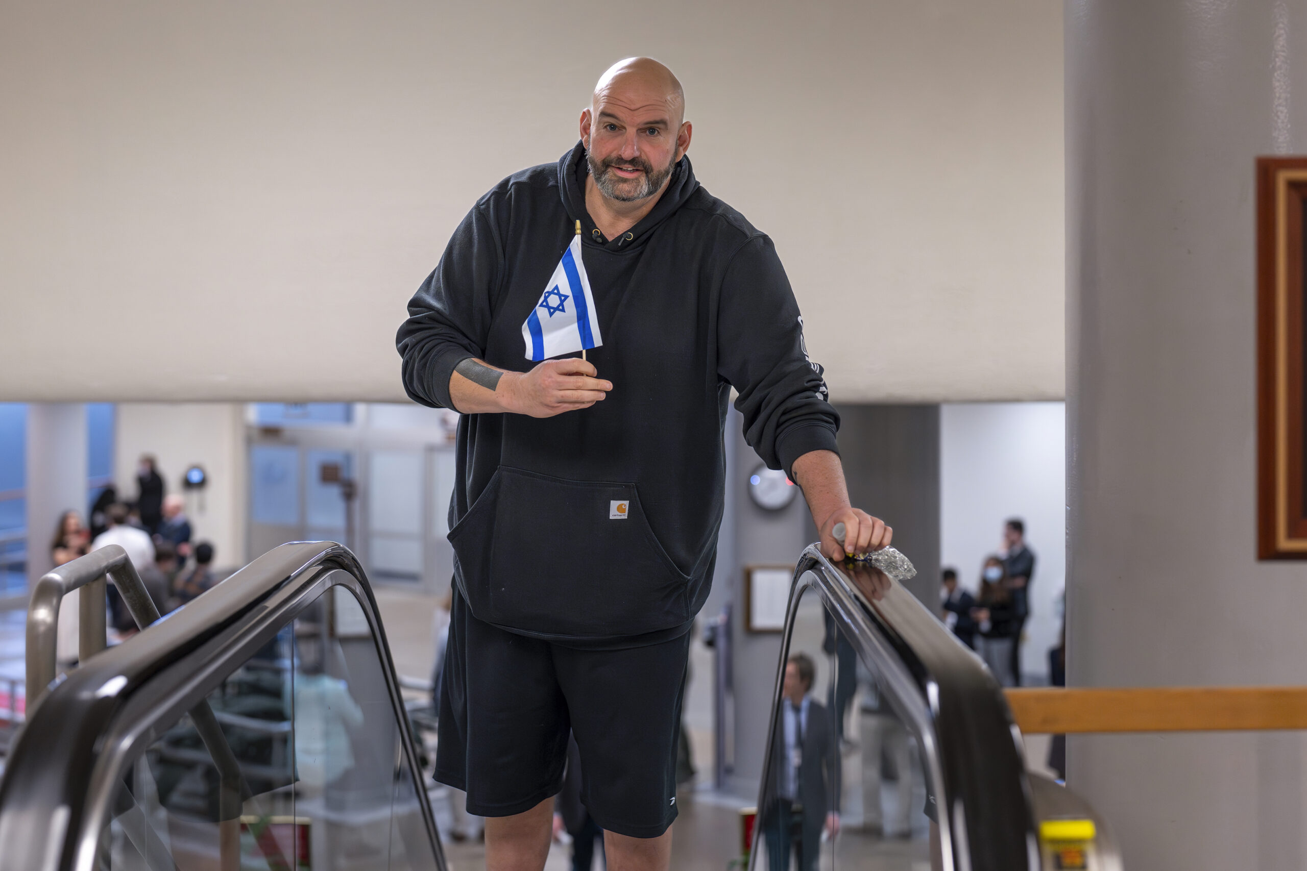 John Fetterman greets protesters outside his home by waving Israeli flag