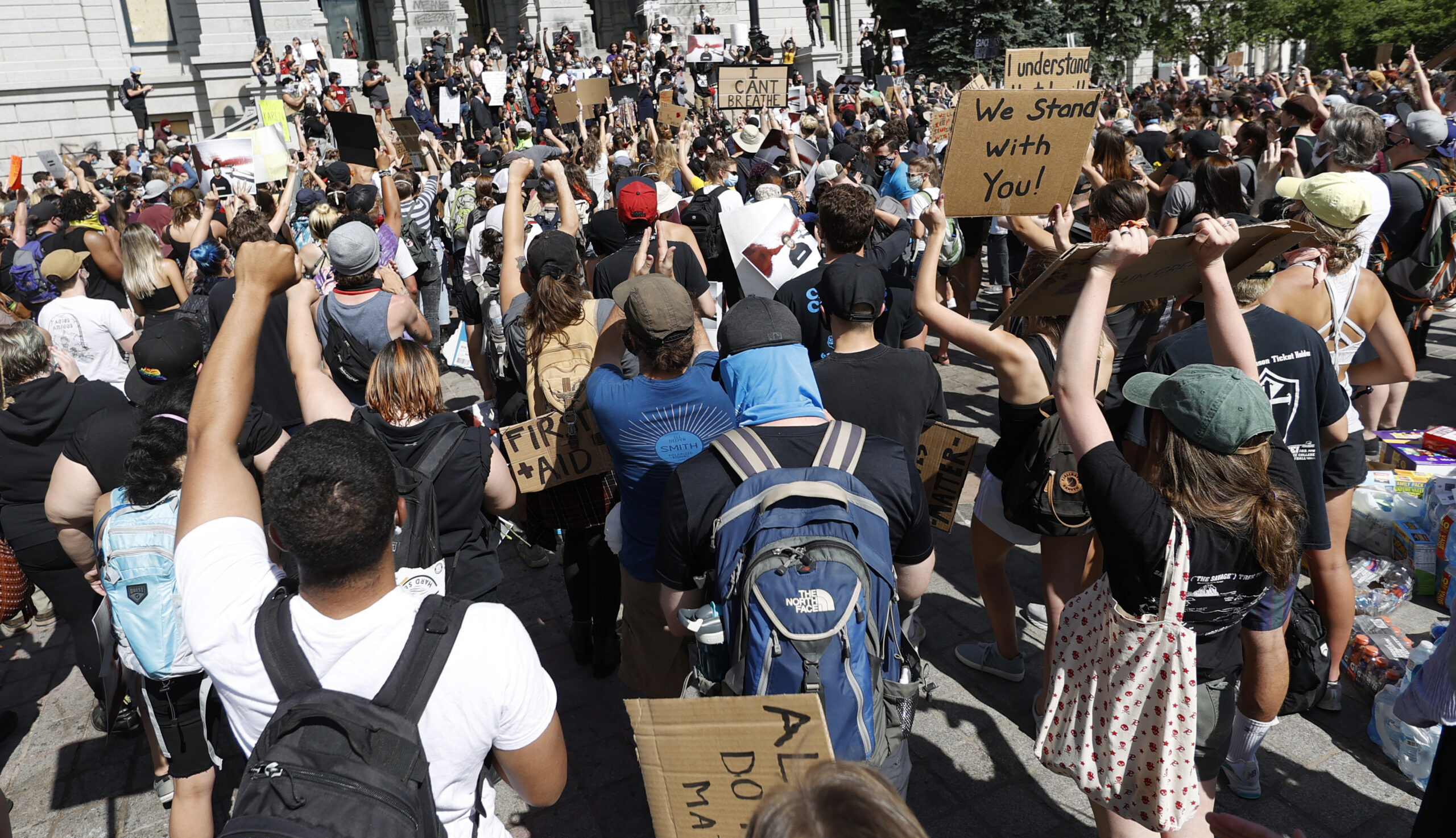 Counterprotesters confront ‘Back the Blue’ activists in Denver, burn MAGA hats, and chant over pro-police crowd
