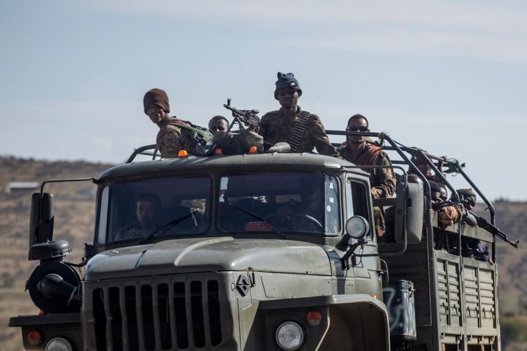 FILE - Ethiopian government soldiers ride in the back of a truck on a road near Agula, north of Mekele, in the Tigray region of northern Ethiopia on May 8, 2021. 