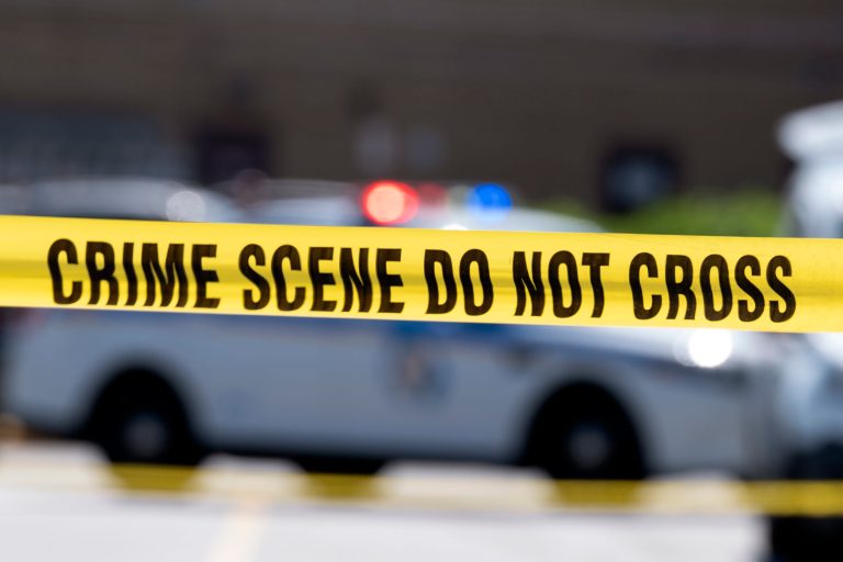 FILE - Yellow crime tape blocks off an area near a mall parking area where two Baltimore city police officers were shot and a suspect was killed as a U.S. Marshals' task force served a warrant, July 13, 2021, in Baltimore, Md. (AP Photo/Jose Luis Magana, File)