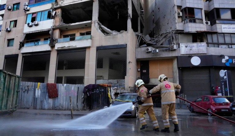 Civil defense workers clean the street in front of an apartment building where an apparent Israeli strike Tuesday killed top Hamas political leader Saleh Arouri, in the southern suburb of Beirut that is a Hezbollah stronghold, Lebanon, Wednesday, Jan. 3, 2024. The apparent Israeli strike that killed Hamas' No. 2 political leader, marking a potentially significant escalation of Israel's war against the militant group and heightening the risk of a wider Middle East conflict.