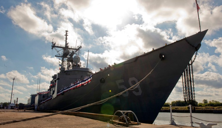 A U.S. Navy ship is docked.