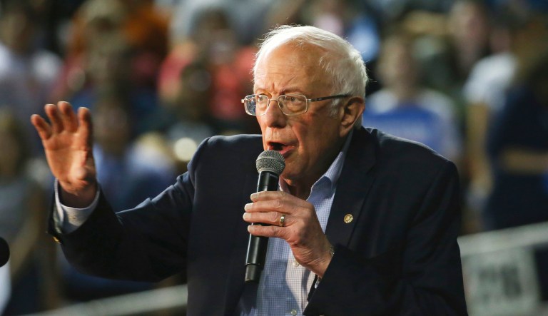 Man waves flag with Nazi swastika at Bernie Sanders rally