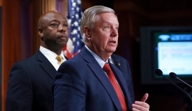 Sen. Tim Scott (R-SC) and Sen. Lindsey Graham (R-SC) speak to reporters in Washington, Wednesday, July 21, 2021. (AP Photo/J. Scott Applewhite)