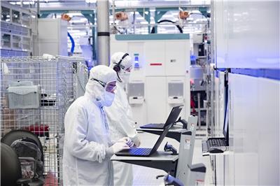 Intel Foundry factory workers researching semiconductors.