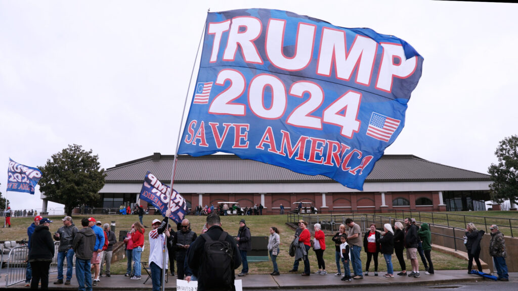 Trump supporters erected a giant "Trump 2024 Save America" flag while waiting in line at one of Donald Trump's largest campaign rally in South Carolina. The line stretched half way around the Winthrop Coliseum on Friday, Saturday 23rd in Rock Hill, South Carolina. (Washington Examiner/Amy DeLaura)
